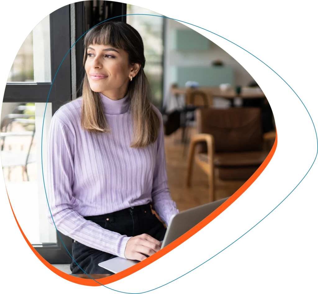 Seo Software 2 Woman on computer looking out of window in office.