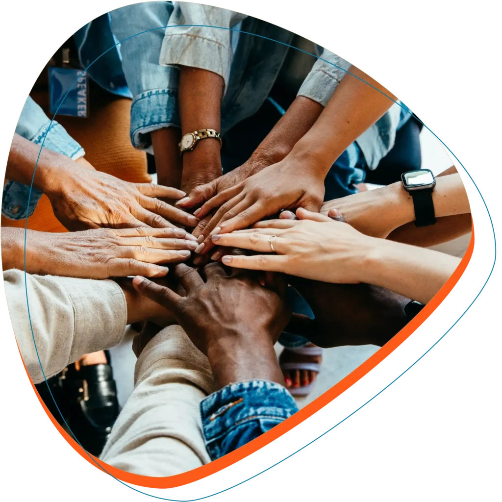 Many people joining hands in a circle